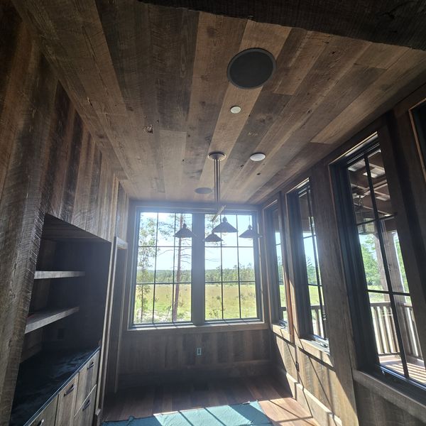 Room with wall sconces and windows