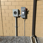 Meter and disconnect on block wall