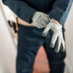 Electrician gearing up in work gloves