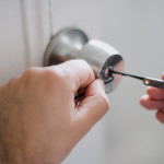 Technician servicing door hardware