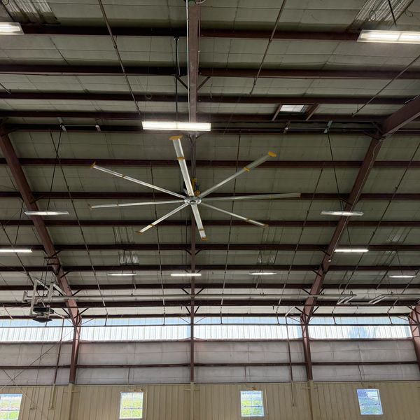 Covered arena lighting with ceiling fan