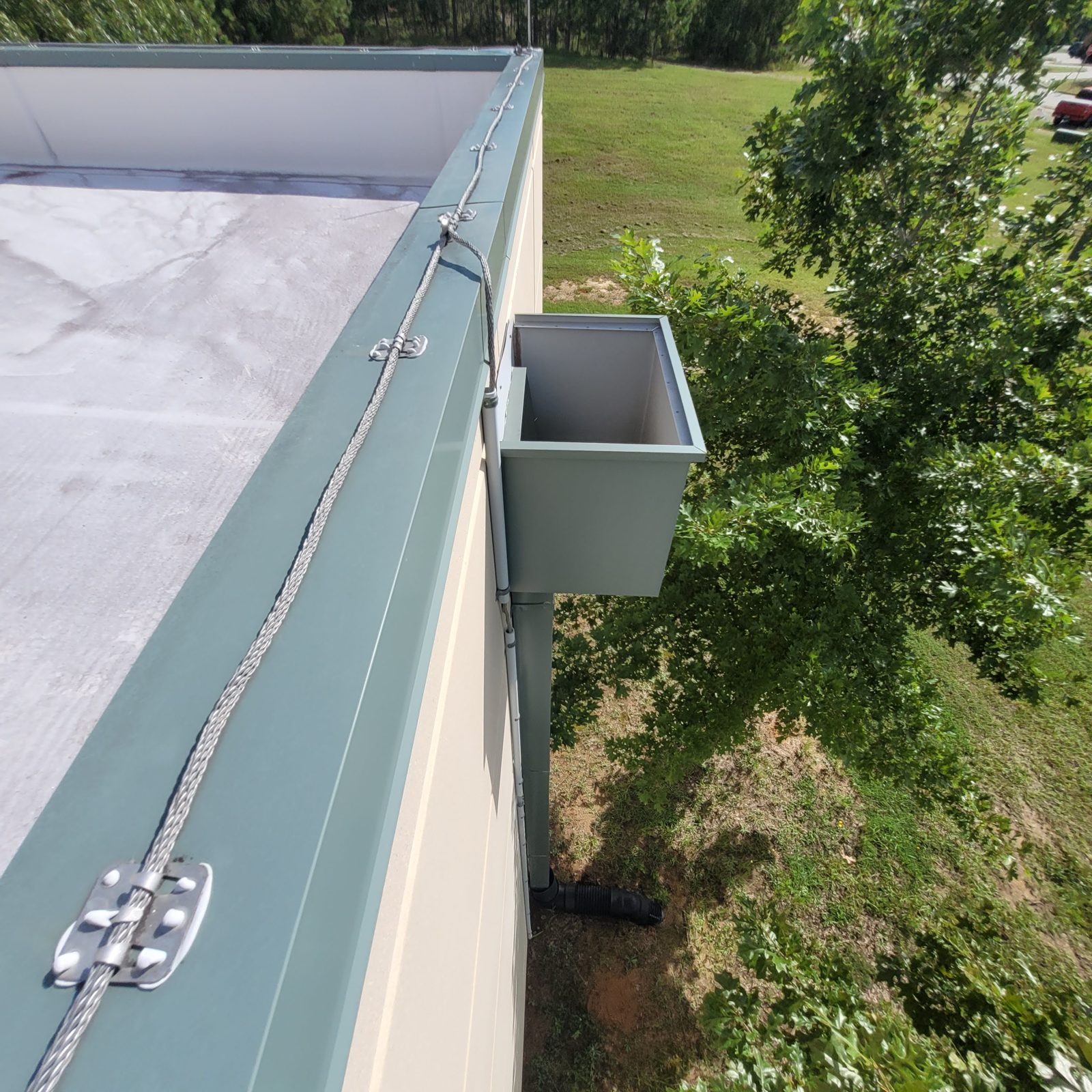Lightning protection conductor run along a rooftop parapet